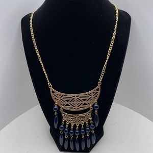 Trendy Necklace with textured gold design and black beads accents.